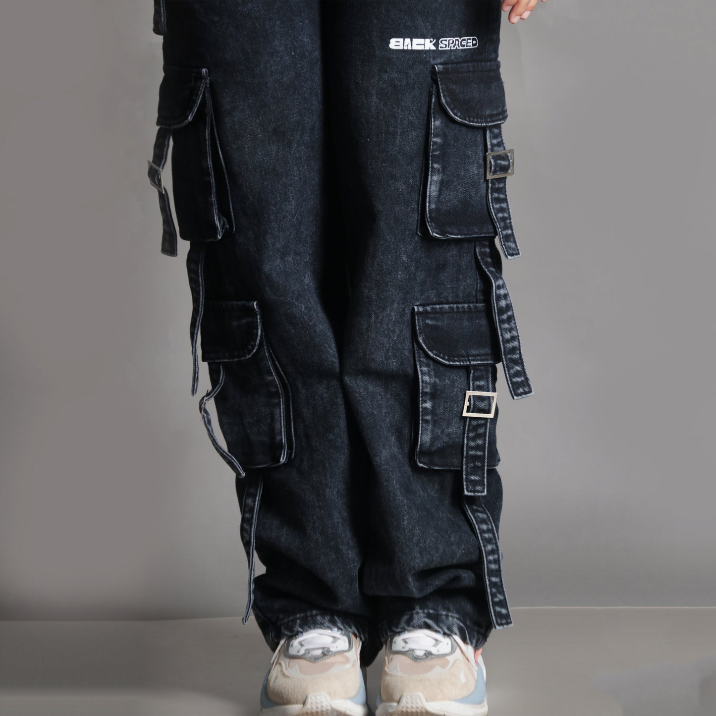 Close-up of the front bottom half of the Midneight Cargo Pants (Women's), highlighting the pocket elements, hemline and lower pocket placement.