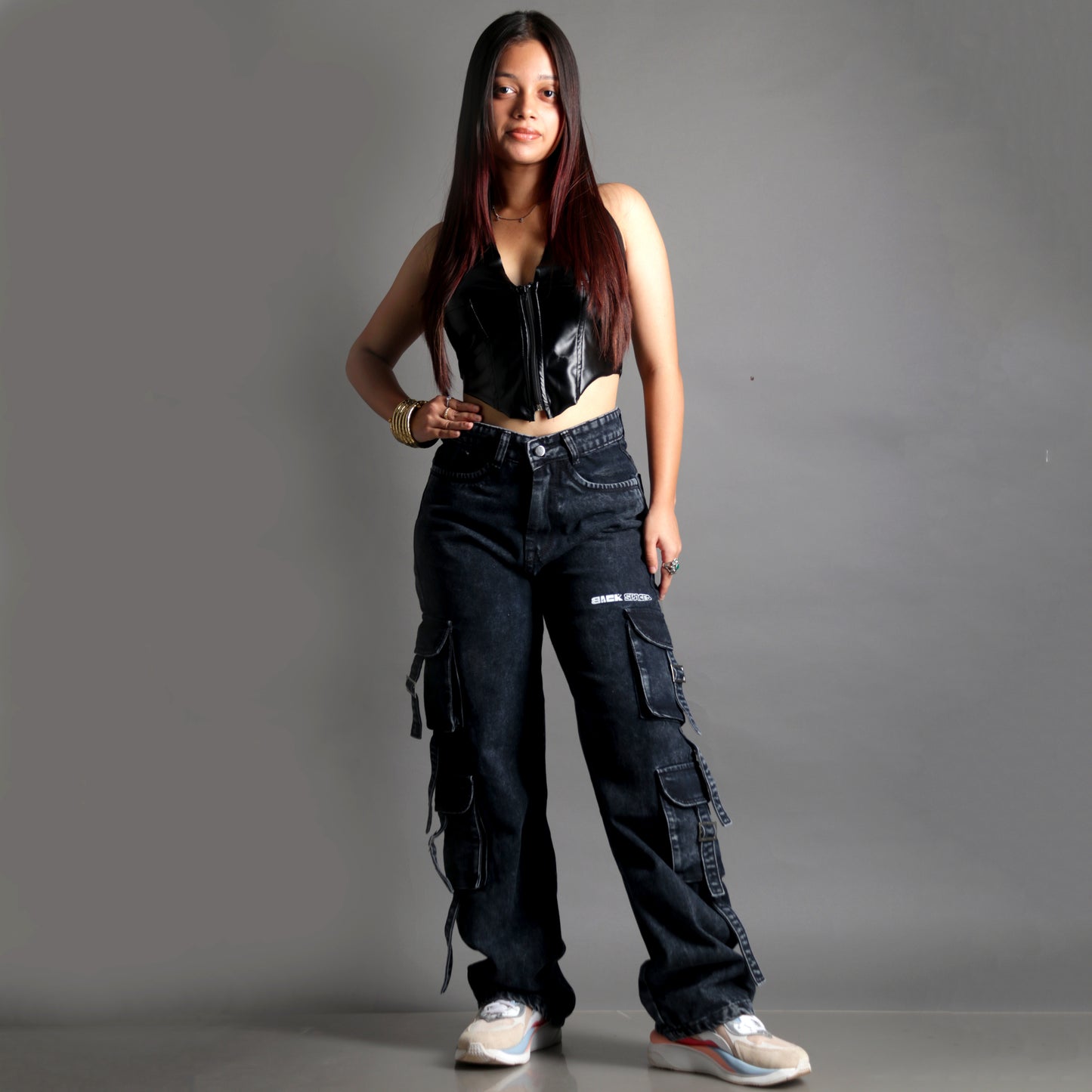 Model wearing the Midneight Cargo Pants (Women's), front view showcasing mid-rise fit and straight-leg, oversized fit.