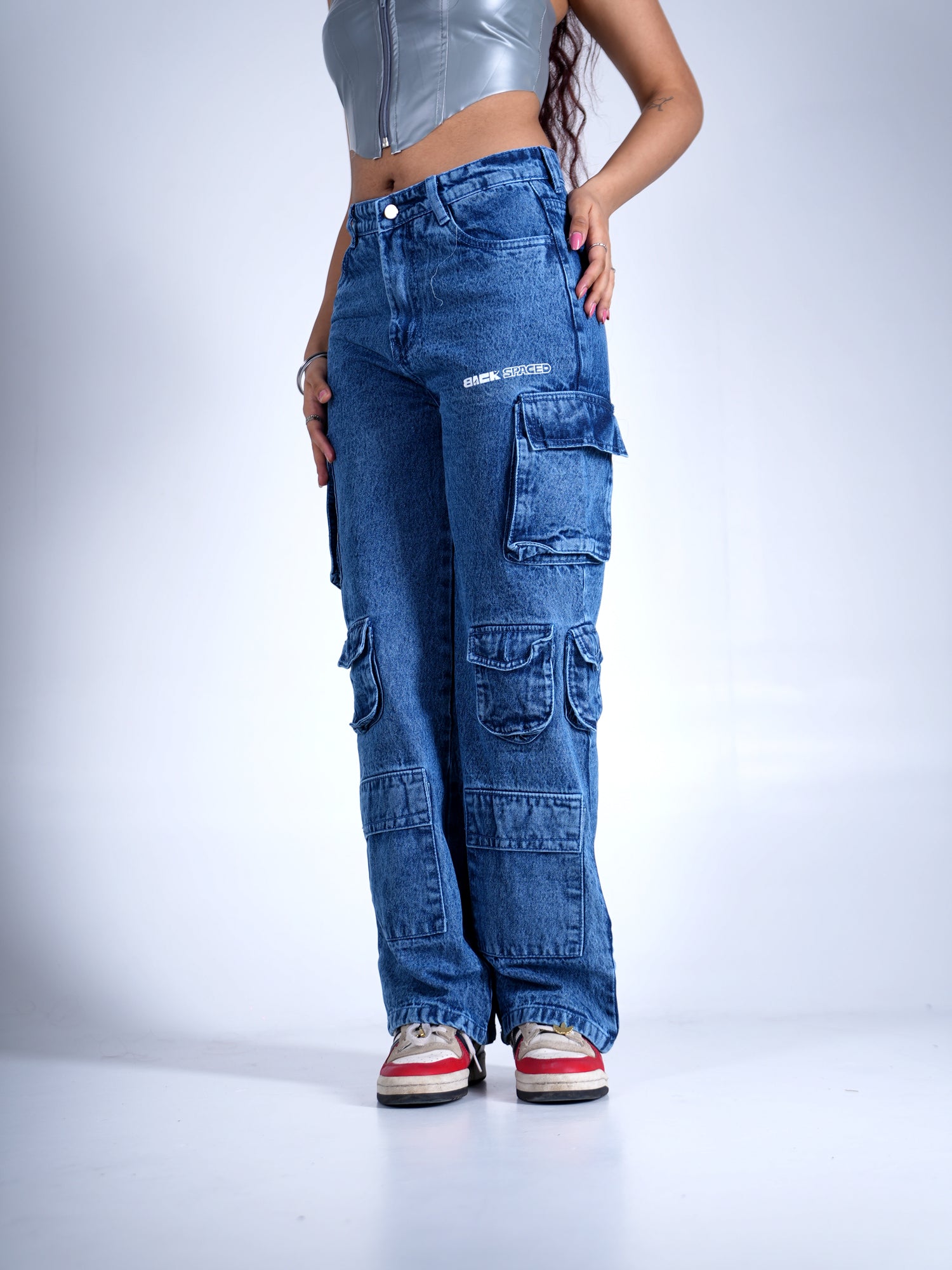 Person wearing blue cargo pants on a white background