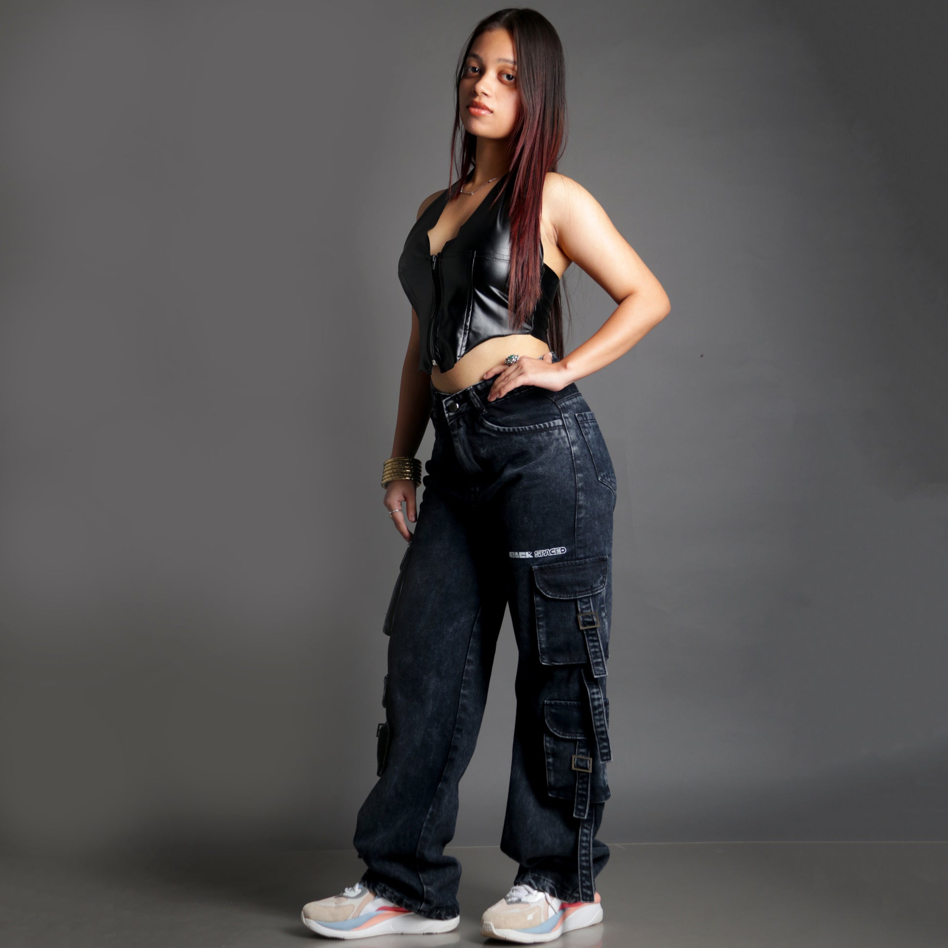 Side profile of model wearing the Midneight Cargo Pants (Women's), showing pocket detailing and the oversized fit.